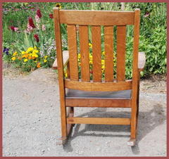 Image of the back of the chair and the decal signature on the left end of the lower stretcher.